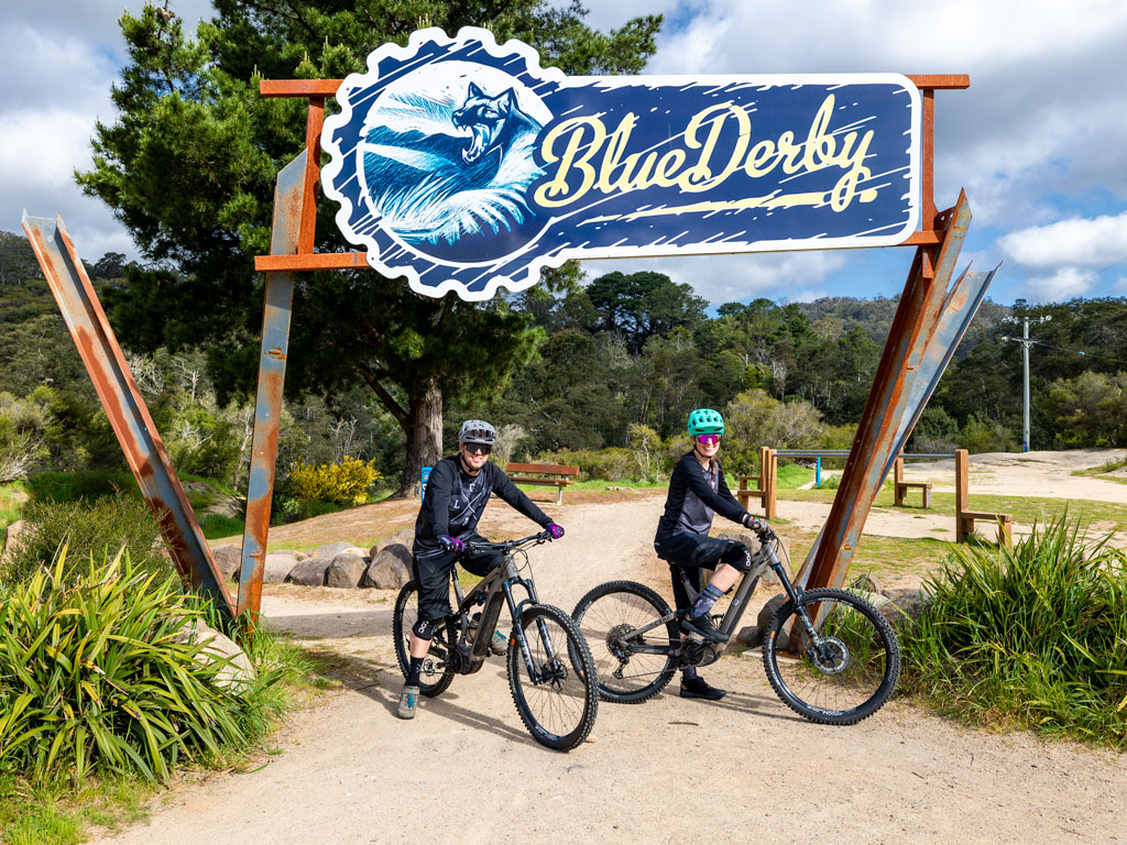 Posing on Derby Hire Bikes under the Blue Derby Trail Head sign